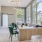 office with desks chairs and a large plant