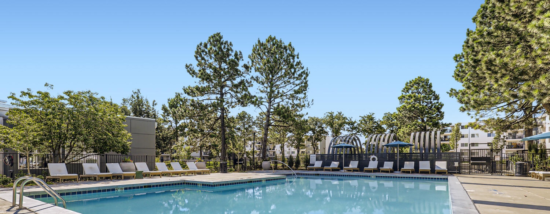 Resort style pool with lawn chairs