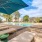 sun beds and umbrellas next to a resort style swimming pool