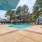 a swimming pool surrounded by sunbeds and umbrellas