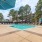 a swimming pool surrounded by sun beds and umbrellas